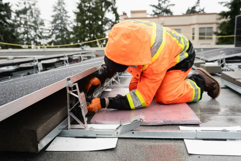Worker repairing roof in bright attire