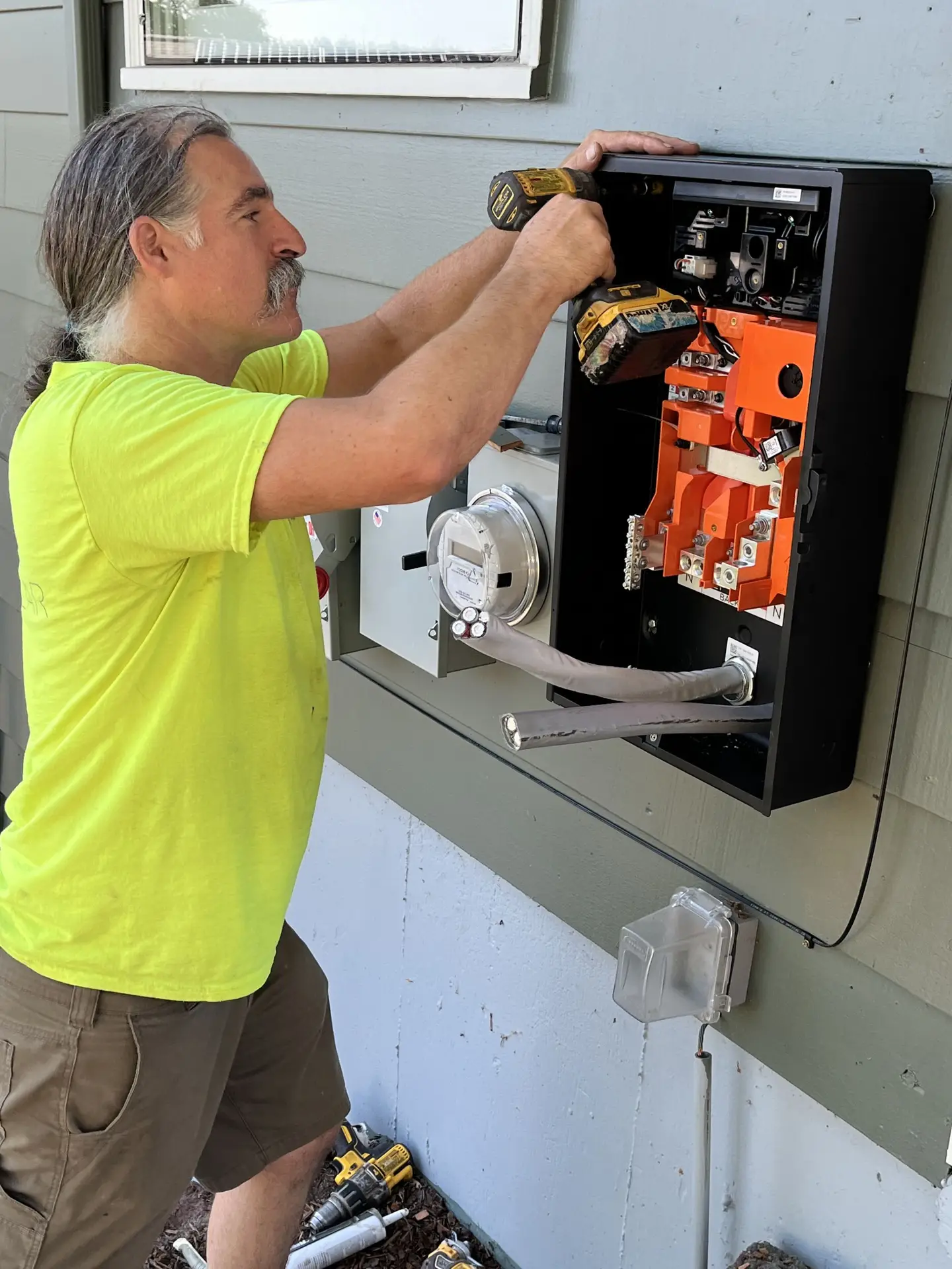 Man working on electrical panel outdoors