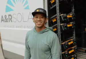 Solar installer in front of a van with logo