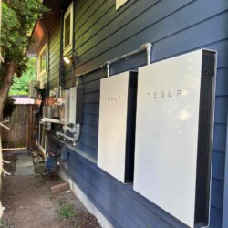 tesla powerwall installed on side of house